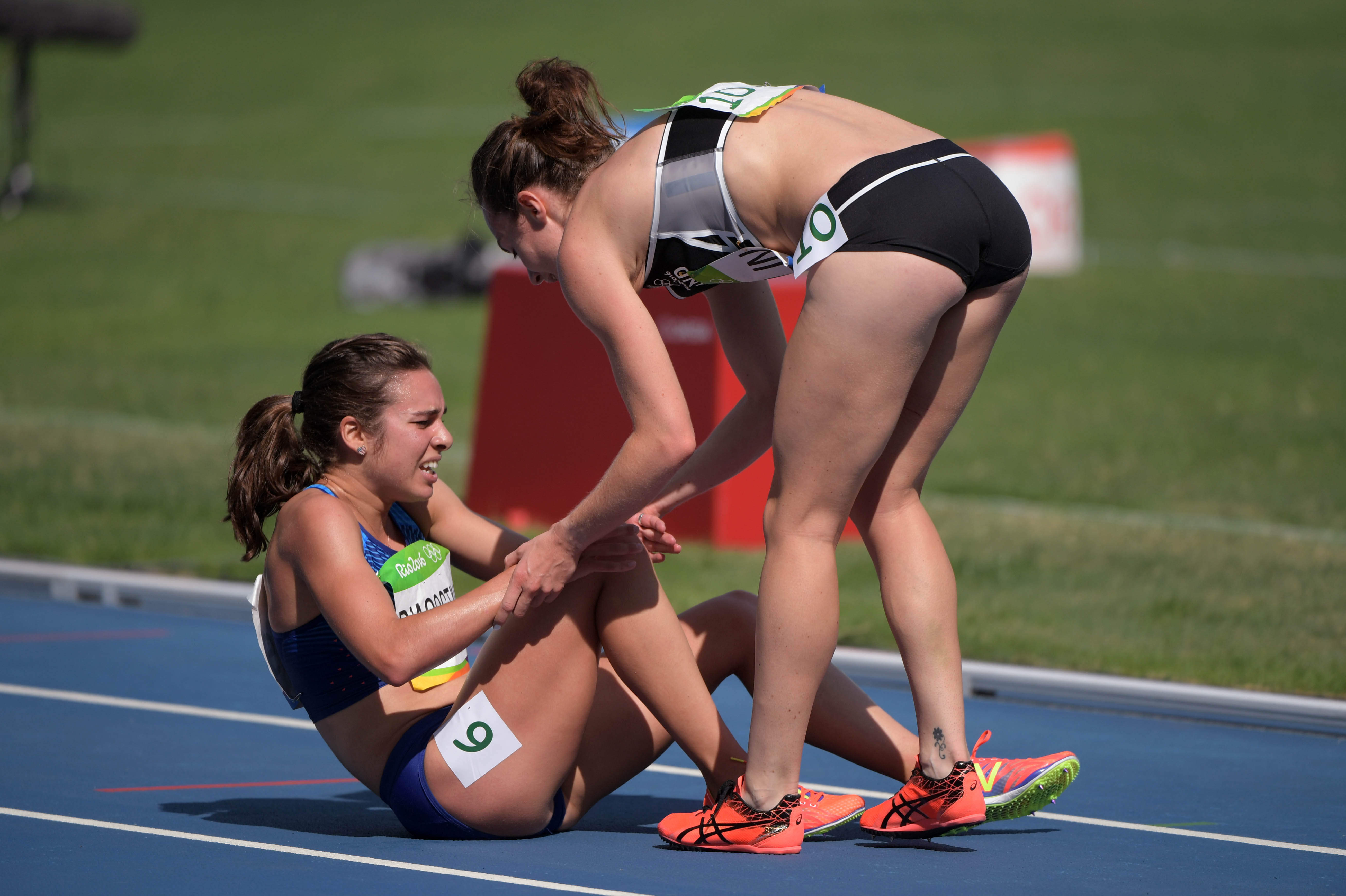 Distance runners Abbey D'Agostino of the United States and Nikki H...